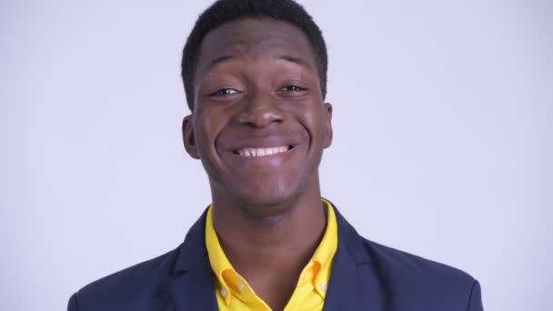 Face of young happy African businessman in suit smiling - Video