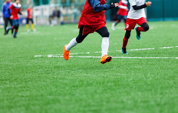 Ποδοσφαιρική προπόνηση ποδοσφαίρου για παιδιά. Τα αγόρια τρέχουν να κάνουν μπάλες ποδοσφαίρου. Νεαροί ποδοσφαιριστές ντρίμπλα και κλωτσά μπάλα ποδοσφαίρου στο παιχνίδι. Εκπαίδευση, ενεργός τρόπος ζωής, Αθλητισμός, έννοια της δραστηριότητας των παιδιών  - Φωτογραφία, εικόνα