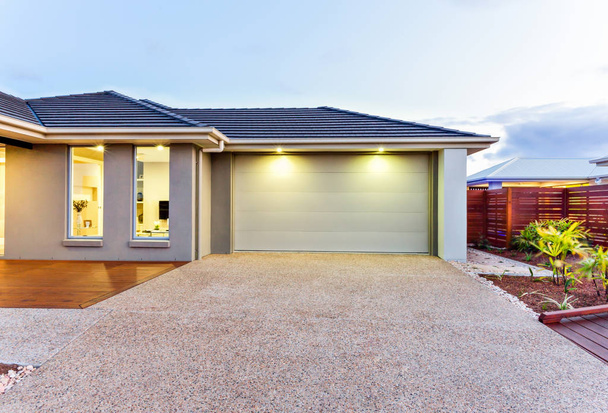Garage with a long and wide concrete or stone yard in front at d - Photo, Image