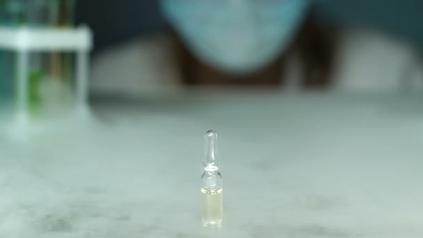 Experienced lab worker taking drug vial, checking quality of new medication - Imágenes, Vídeo