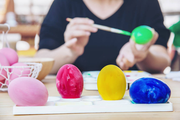 People painting colourful Easter eggs - people celebration national holiday concept - Fotografie, Obrázek