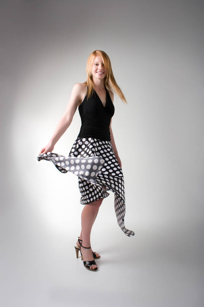 Playful model in a long skirt spinning in the studio  - Fotoğraf, Görsel