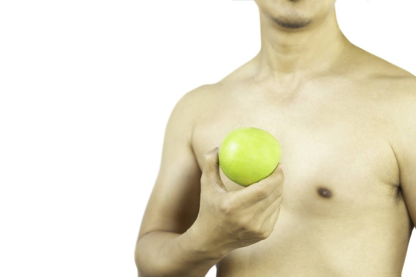 Healthy naked man holding a fresh green apple isolated in clipping path. - Foto, imagen