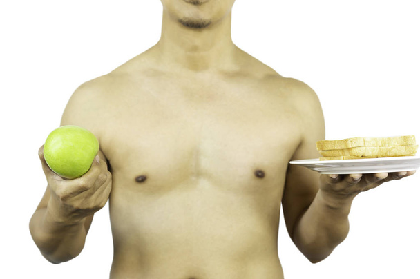 Man holding green apple and slice of bread in clipping path. - Photo, Image