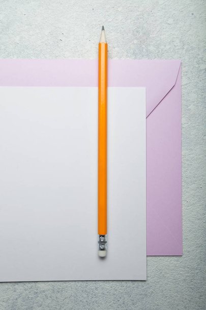 The concept of paper writing. Pencil, paper and pink envelope on - Photo, Image
