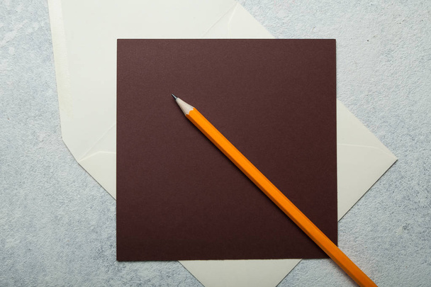 Blank letterhead and orange pencil on white vintage background. - Foto, immagini