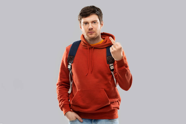 male student with school bag showing middle finger - Zdjęcie, obraz