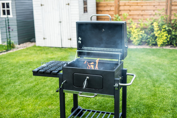 Grill with prepared charcoal for grilling outdoors on backyard - Photo, Image