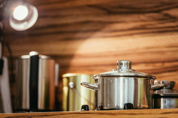 Steaming metal pot in the kitchen, wood - Φωτογραφία, εικόνα