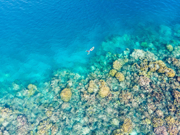 Aerial top down people snorkeling on coral reef tropical caribbean sea, turquoise blue water. Indonesia Banyak Islands Sumatra, tourist diving travel destination. - Photo, Image