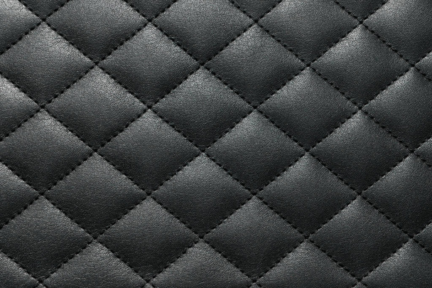 Donkergrijs lederen textuur achtergrond met een draad over cross gestikt. Close-up van bovenaf. - Foto, afbeelding