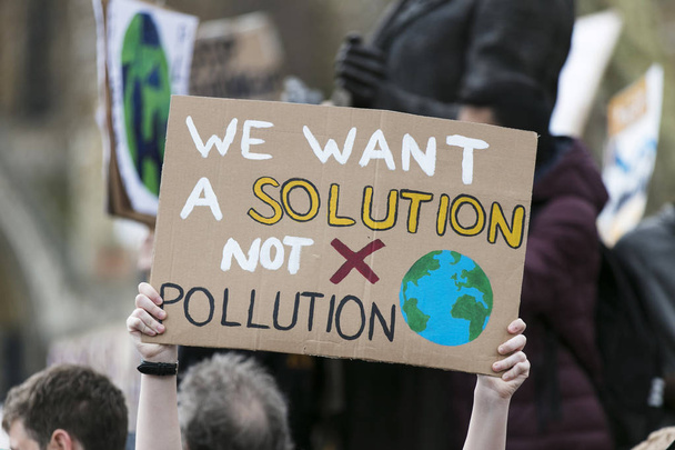 People with banners protest as part of a climate change march - Foto, imagen