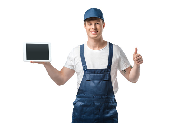 smiling mover looking at camera, showing thumb up and presenting digital tablet with blank screen isolated on white - 写真・画像