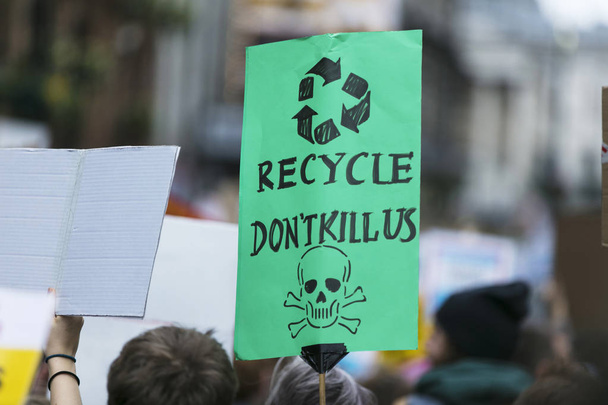 People with banners protest as part of a climate change march - Photo, Image