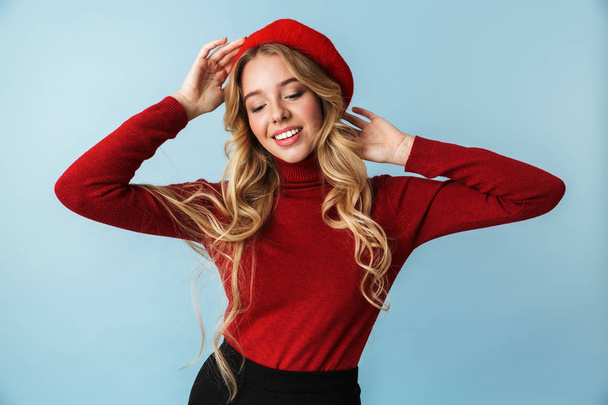 Portrait of positive blond woman 20s wearing red beret smiling w - Фото, изображение