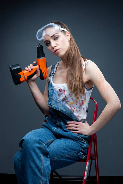 Woman builder portrait with drill.  - Фото, зображення