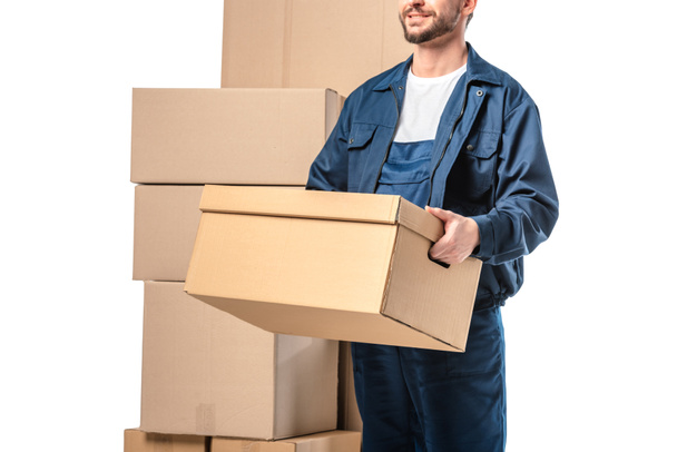 cropped view of mover in uniform carrying cardboard box isolated on white - Foto, Bild