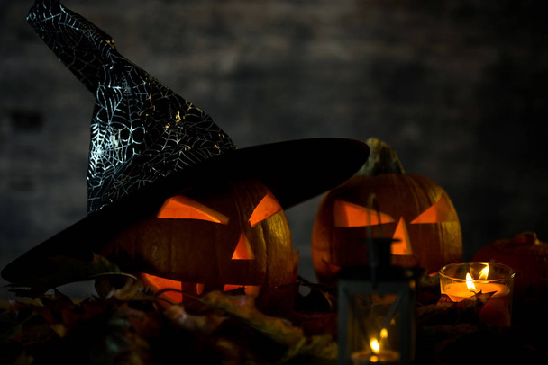 Scary orange pumpkins with candle fire. Halloween celebration concept. - Photo, Image