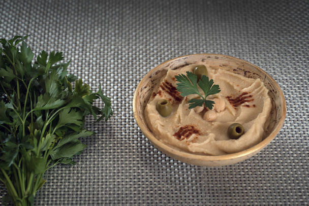 hummus with fresh chickpeas and parsley, traditional Levantine dip - Photo, Image