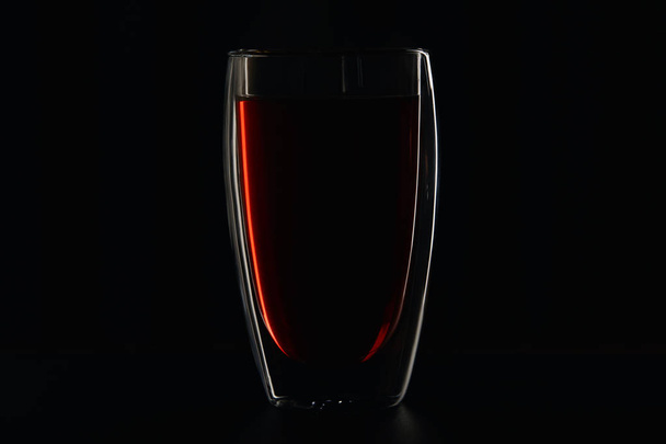 Glass full of burgundy red wine on black - Fotografie, Obrázek