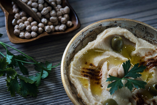 hummus with fresh chickpeas and parsley, traditional Levantine dip - Фото, изображение