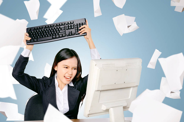 Stressed asian business woman with flying paper scattered want t - Photo, image