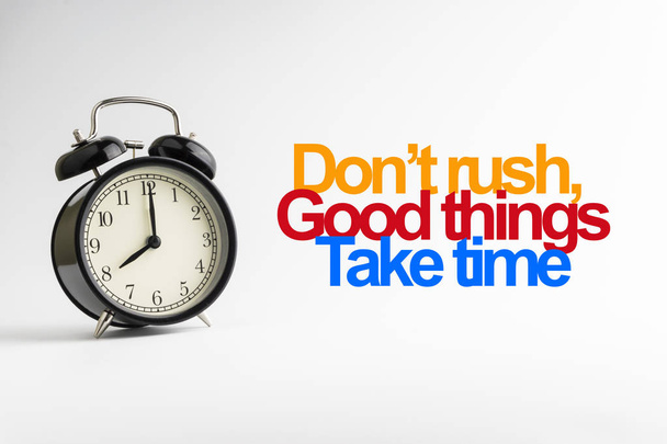 DON'T RUSH GOOD THINGS TAKE TIME inscription written and alarm clock on white background. Business and motivation concept - Photo, Image