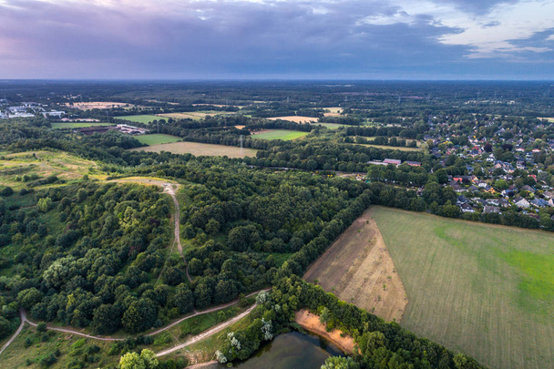 Aerial view of amazing sunset over the park in Germany. Hill and lake from birds eye view. - Photo, Image