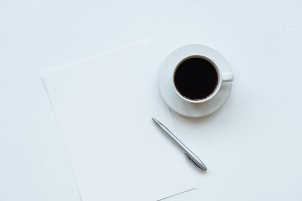 Cup of coffee, piece of paper and pen on the table. Top view - Foto, imagen