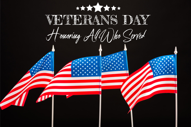 american flags with veterans day lettering isolated on black - Photo, Image