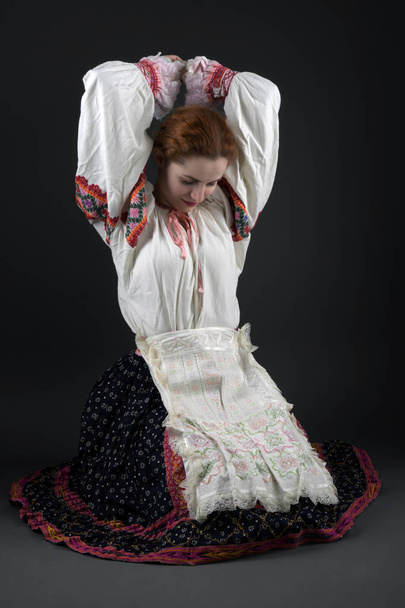 Young beautiful slovak woman in traditional dress. Slovak folklore - Foto, imagen