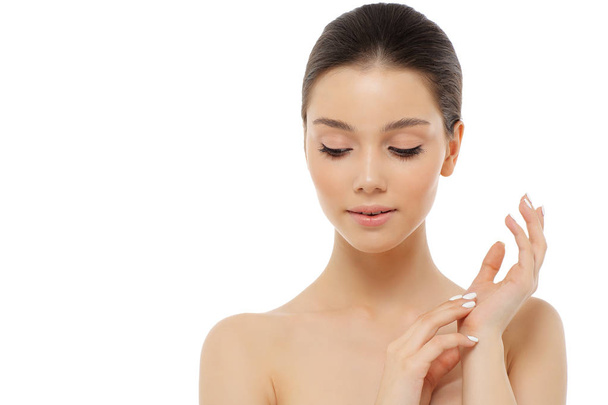 Portrait of a beautiful young woman, skin care and hands with ma - 写真・画像