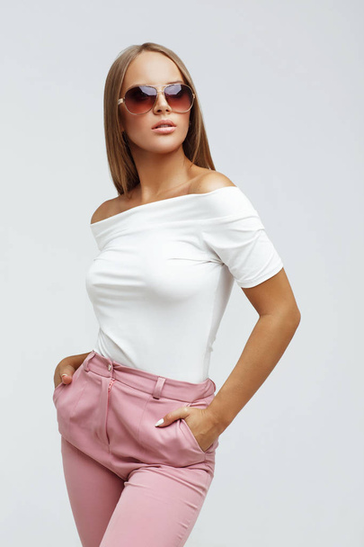Fashion portrait of a young woman in sunglasses - Photo, image
