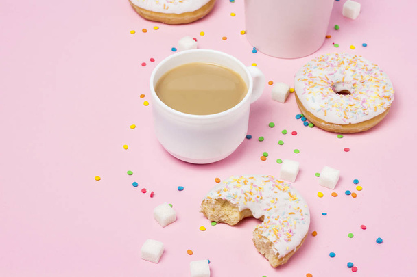 Cups with coffee or tea, Fresh tasty sweet donuts on a pink background. Fast food concept, bakery, breakfast, sweets, coffee shop. Flat lay, top view, copy space. - Photo, image