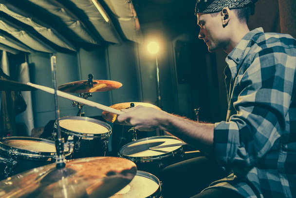 enfoque selectivo del baterista sosteniendo palos de tambor mientras toca la batería
  - Foto, imagen