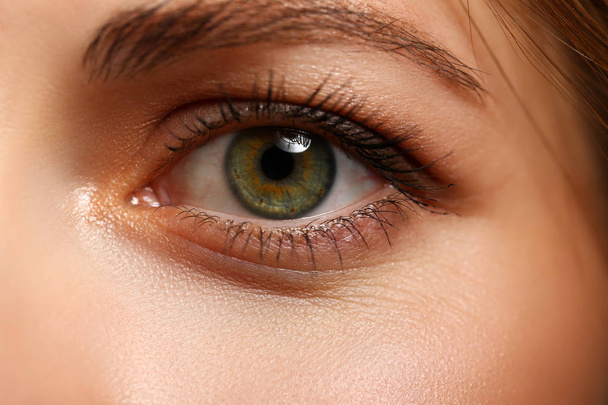 Female left emerald green coloured eye extreme closeup - Fotó, kép