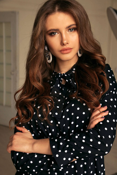 beautiful woman with dark hair in elegant blouse and accessories - Zdjęcie, obraz