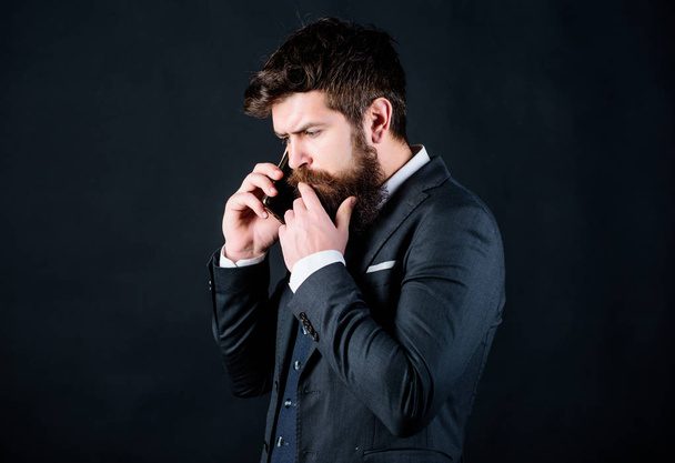 Mobile call concept. Mobile call conversation. Mobile negotiations. Businessman well groomed mature man hold smartphone. Guy call friend stand black background. Man formal suit call someone - Photo, Image