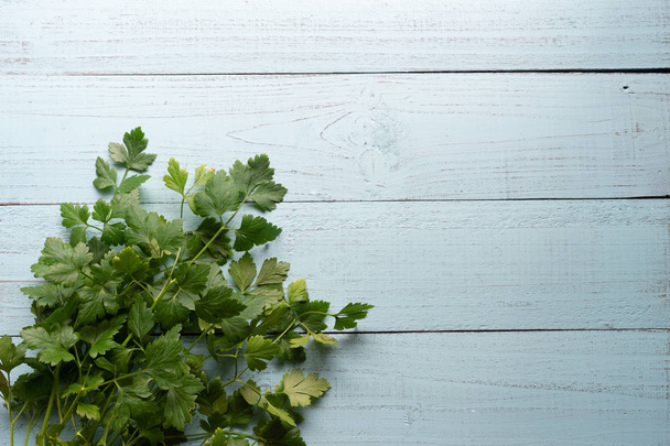 Fresh parsley on  wooden background with copy space - Photo, Image