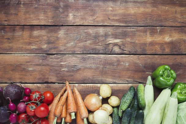Fresh organic farm vegetables, Health care, on a wooden background. Harvest. Country style. Concept of a farm fair. Flat lay, top view. Copy space - Photo, image