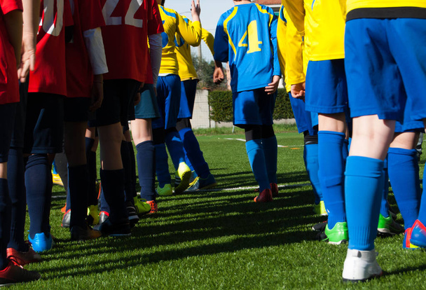 Piernas de dos equipos de niños de fútbol
 - Foto, imagen