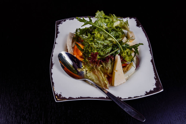 Salad with egg, red pepper, cheese and tomato served on a plate. - Photo, Image