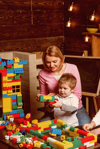 Mother concept. Mother and son play toy bricks. Mother and child building structure model with blocks. My mother is wonderful. Mothers day - Photo, Image