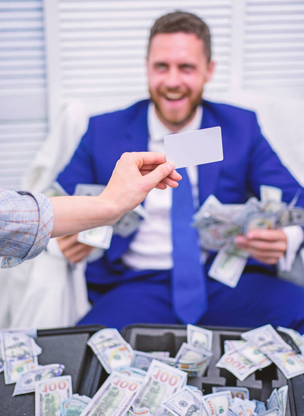 Excited successful businessman opened a box with money and rejoices in profits. Rich person. Business, people, success and fortune concept. - Foto, Imagen