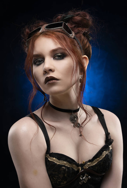 A beautiful redhead cosplayer girl wearing a Victorian-style ste - Фото, изображение