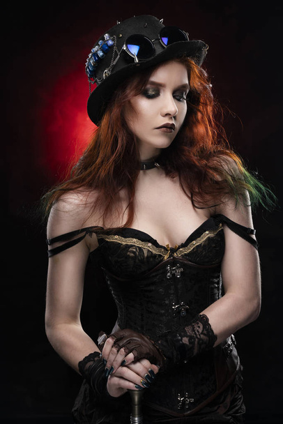 Beautiful redhead cosplayer girl wearing a Victorian-style steam - Фото, изображение