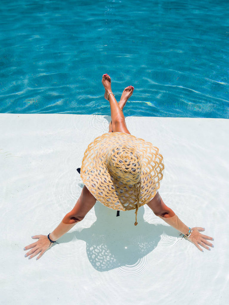 Woman relaxing in swimming pool at spa resort. r - Фото, зображення