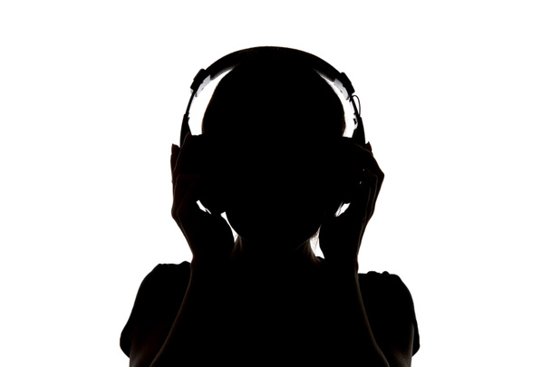 Silhouette of girl in headphones listening music in headphones isolated on white - Photo, Image
