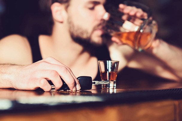 Stay alive, dont drink and drive. Handsome man with car keys drink beer at bar counter. Man drinker in pub. Alcohol addict with beer mug. Alcohol addiction and bad habit. Addicting to alcoholic drink - Photo, Image