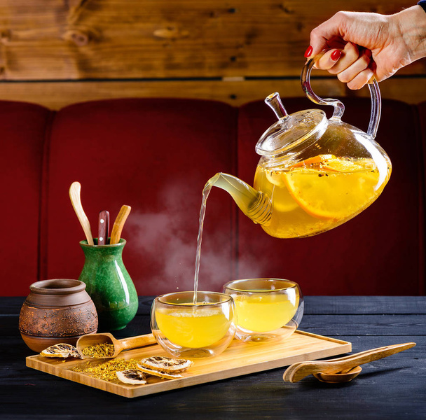 ginger tea with orange in a glass teapot - Photo, image